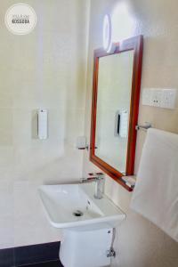 a bathroom with a white sink and a mirror at Villa 252 Kosgoda in Kosgoda +174 photos