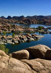 a large body of water with rocks and mountains at Antelope Hills Inn in Prescott