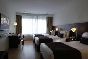 A bed or beds in a room at Dazzler by Wyndham Lima Miraflores