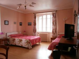 a bedroom with two beds and a window at Hôtel Modern in Concarneau