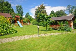 a park with a playground with a slide at Privát Majo - Váš oddych na Liptove in Liptovský Mikuláš