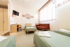 - une salle d'hôpital avec 2 lits et un canapé dans l'établissement Casa per Ferie Opera Don Calabria, à Rome