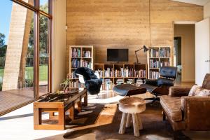 a living room filled with furniture and a large window at Arinya Retreat Daylesford in Daylesford