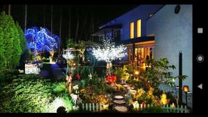 a garden with christmas lights and a house at Kakureyado Fujikawaguchiko in Fujikawaguchiko