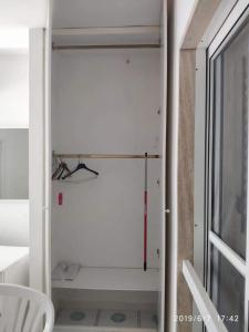 a room with a white closet with a glass door at Rosa Marina Frontline Beach in Ostuni