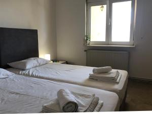 a bedroom with two beds with towels on them at Blue Sky in Frangokastello