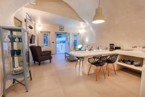a kitchen and dining room with a table and chairs at Hidden Treasure Suites in Vóthon