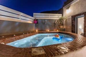 a swimming pool in a house at night at Hidden Treasure Suites in Vóthon
