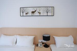Postel nebo postele na pokoji v ubytování De House Hotel