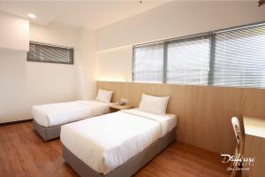 Postel nebo postele na pokoji v ubytování De House Hotel