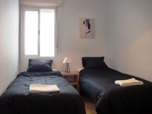 two beds sitting next to each other in a bedroom at Ayamonte Mirador in Ayamonte