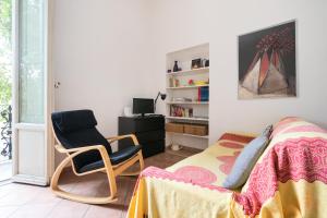 a bedroom with a bed and a chair and a desk at Appartamento Boboli in Florence