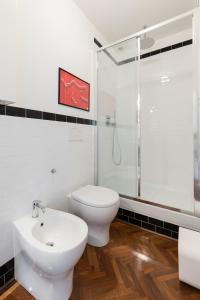 a bathroom with a toilet and a sink and a shower at Appartamento Boboli in Florence +14 photos