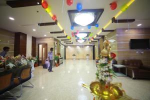 a lobby with a person standing in a building at Hotel SVM Grand Medipally in Upal