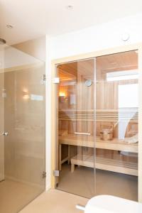 a glass walk in shower in a bathroom at Intermar Hotel & Apartments in Glücksburg