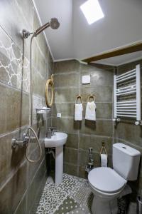 a bathroom with a toilet and a sink at Apartment Ornament in Tbilisi City