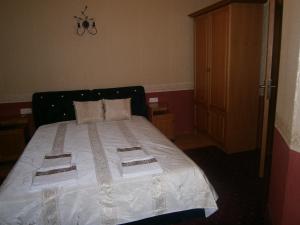 a bedroom with a bed with two towels on it at Evia Hotel in Berkovitsa