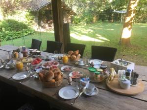 a wooden table with breakfast food on it at Bed en Breakfast De Kees in Eersel +43 photos