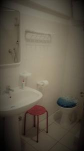 a bathroom with a toilet and a sink and a stool at Le Acacie Felici in Terni