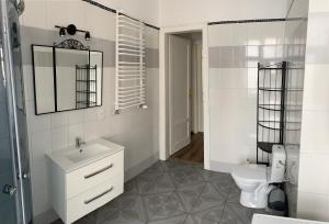 a white bathroom with a sink and a toilet at Apartament Równa 12 in Kielce