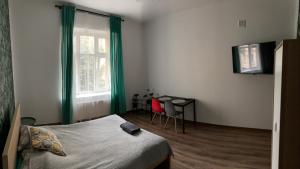 a bedroom with a bed and a window and a chair at Apartament Równa 12 in Kielce