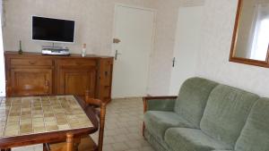 - un salon avec un canapé, une table et une télévision dans l'établissement PIED A TERRE 4, à Amélie-les-Bains-Palalda