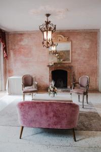 a living room with a couch and a fireplace at Regina Teodolinda Suites in Laglio