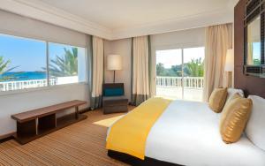a hotel room with a bed and a balcony at OCEANA Hotel & Spa in Hammamet +37 photos