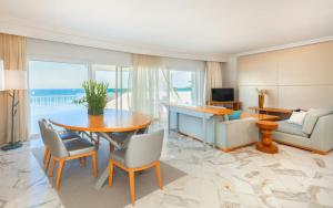 a living room with a table and a couch at OCEANA Hotel & Spa in Hammamet