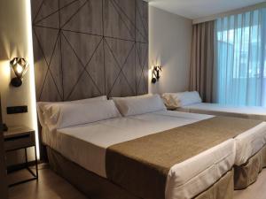 Łóżko lub łóżka w pokoju w obiekcie Hotel Bristol 4 Sup