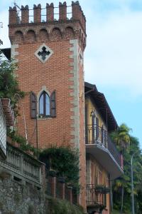 a brick building with a clock tower on it at B&B Torre Lara in Belgirate