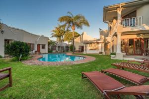 a house with a swimming pool in the yard at Millbury Guest House in Port Elizabeth