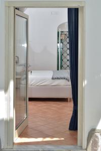 a view of a bedroom with a bed through a mirror at Casa Amorino in Minori
