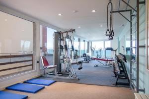 a gym with treadmills and machines in a building at Hotel Las Rocas in Mar del Plata