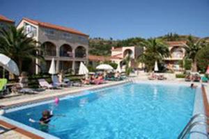 a large swimming pool with a person in the water at Daniel Hotel in Kalamaki