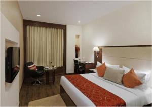 Säng eller sängar i ett rum på Hotel DS Clarks Inn Gurgaon