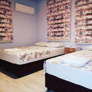 a room with two beds and a wall with flags at otel denizyıldızı in Fethiye