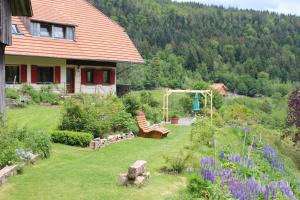 a backyard with a garden with a gazebo at The Moosbach Garden in Nordrach