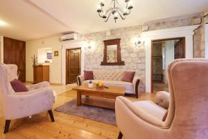 a living room with a couch and chairs and a table at Apartment Capo Residence - Old Town - Parking in Trogir
