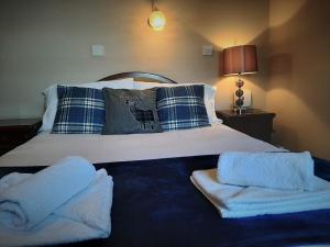 a bedroom with a bed with towels on it at The Imperial Hotel in Castle Douglas