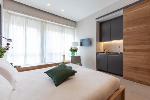 Posteľ alebo postele v izbe v ubytovaní BePlace Garibaldi Suites