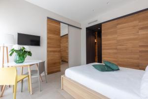 Posteľ alebo postele v izbe v ubytovaní BePlace Garibaldi Suites
