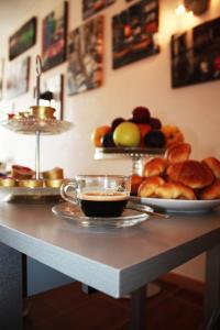 a table with a cup of coffee and a plate of bread at Hotel Giulietta e Romeo in Casal Palocco