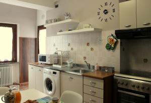 a kitchen with a sink and a washing machine at Maison Teresa CIR 0161 in Aosta