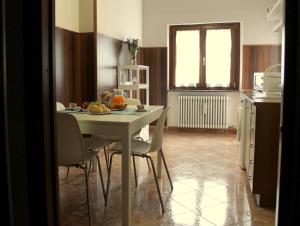 a kitchen with a white table and chairs in a room at Maison Teresa CIR 0161 in Aosta