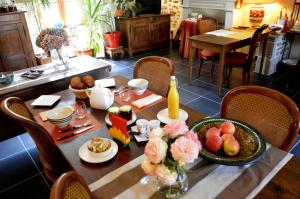 a table with a breakfast of food on it at Les gîtes du bourg in Vitrac +12 photos