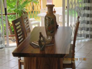 a wooden table with a vase on top of it at VILLA CANELLE in Trou aux Biches