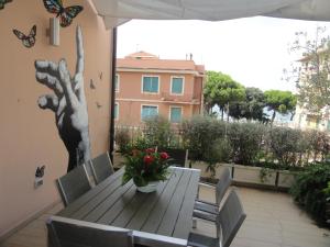 a table and chairs on a patio with butterflies on the wall at Sapore di mare in Sestri Levante