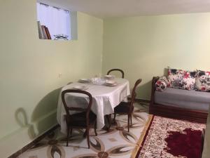 a table and chairs in a room with a couch at Naima appartment in Moulay Bousselham
