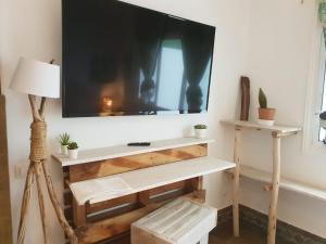 a living room with a tv on a wall at Cactus Host in Las Palmas de Gran Canaria